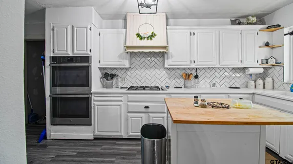 a kitchen with stainless steel appliances cabinets and a window