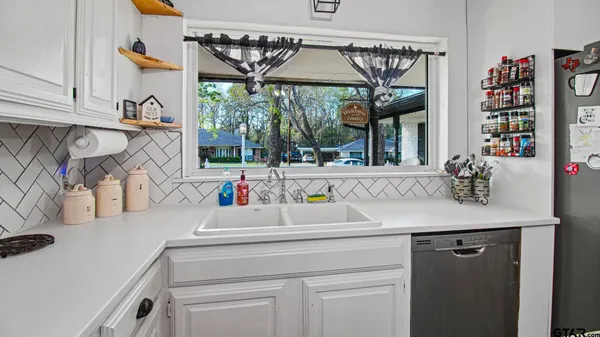 a kitchen with a sink and a refrigerator