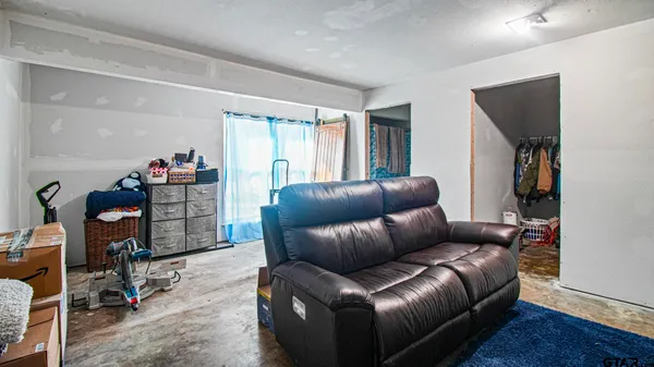 a living room with furniture a ceiling fan and a window