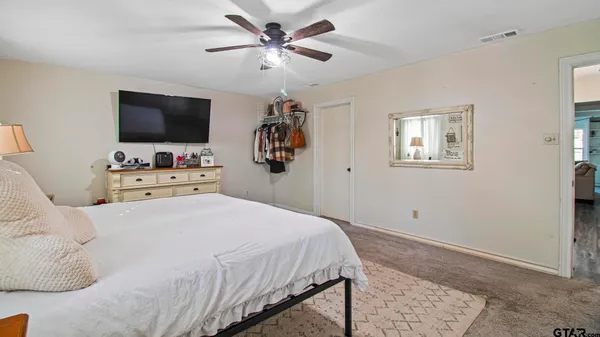 a bedroom with a bed and a flat screen tv