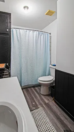 a bathroom with a toilet and a shower