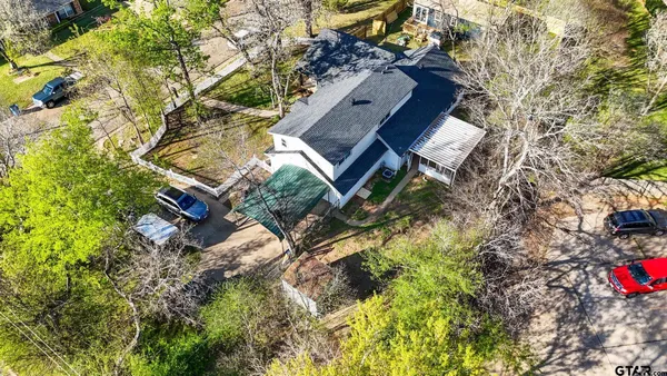 a aerial view of a house with a yard and sitting area