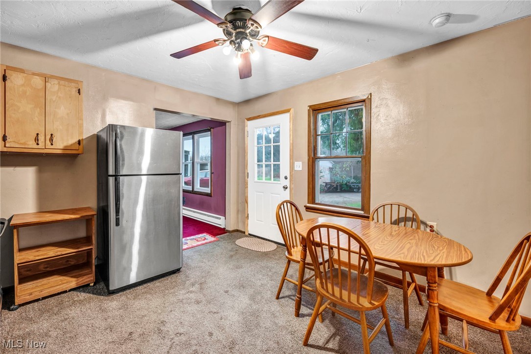 9982 Crow Road Litchfield, OH 44253 - Photo 35 of 41 Carpeted dining area with ceiling fan, a textured ceiling, and a baseboard heating unit