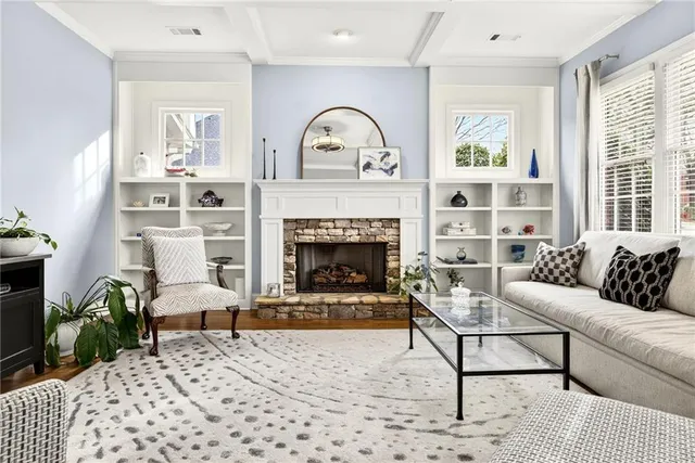a living room with furniture and a fireplace