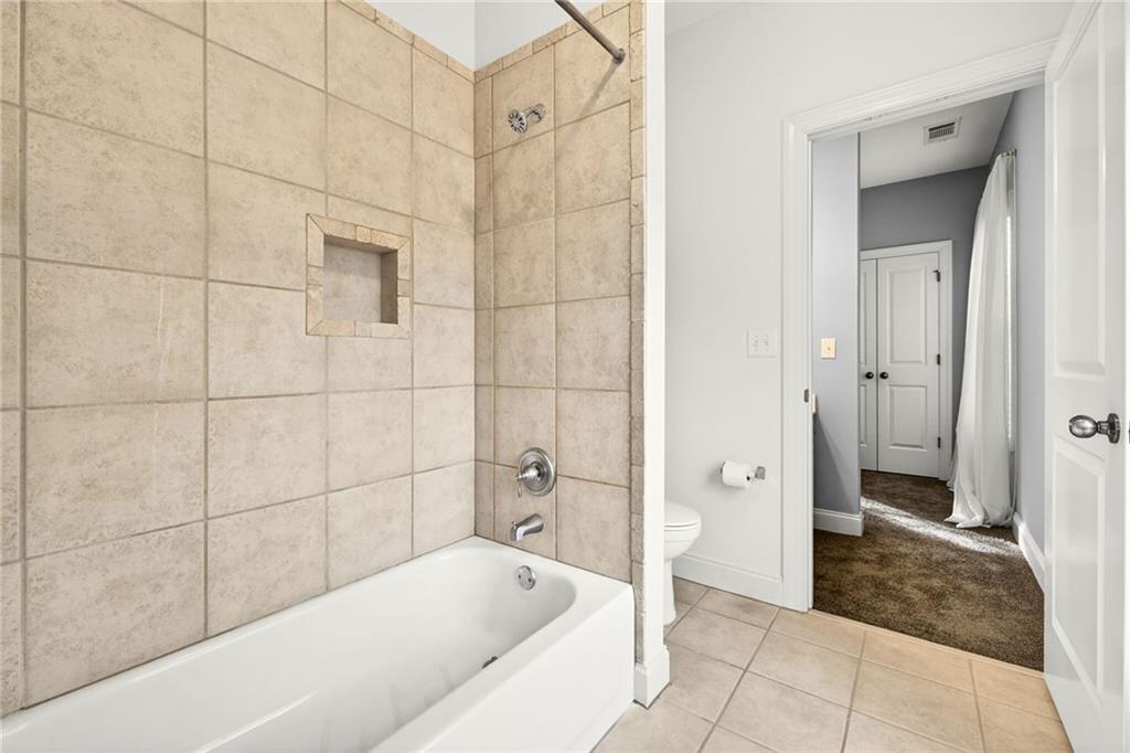 455 High Pointe Trail Roswell, GA 30076 - Photo 34 of 46 a bathroom with a bathtub and a shower