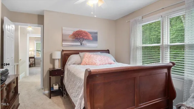 a bedroom with a bed and a painting on the wall