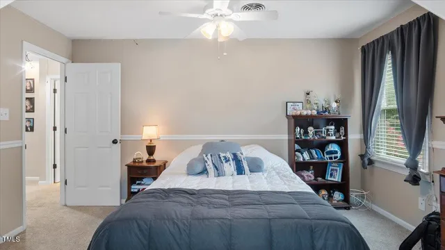 a bedroom with a large bed and a chandelier
