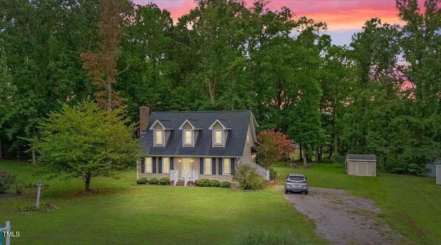 an aerial view of residential houses with outdoor space and swimming pool