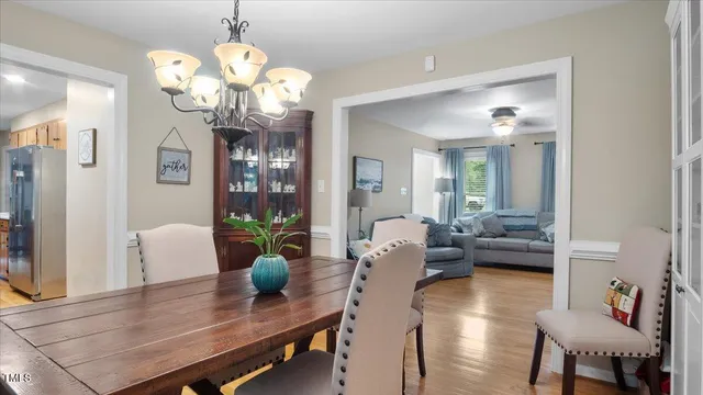 a living room with fireplace furniture and a chandelier