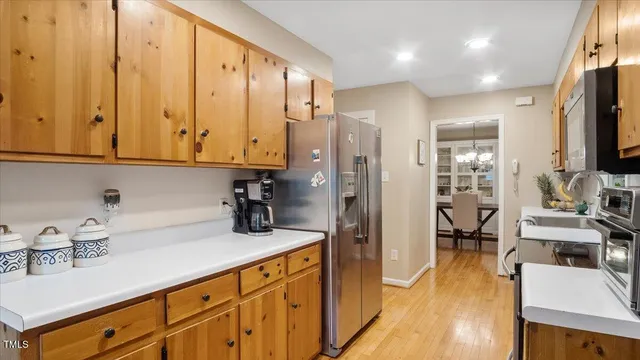 a kitchen with stainless steel appliances granite countertop a sink refrigerator and cabinets