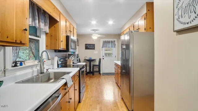 a kitchen with stainless steel appliances sink a microwave and cabinets