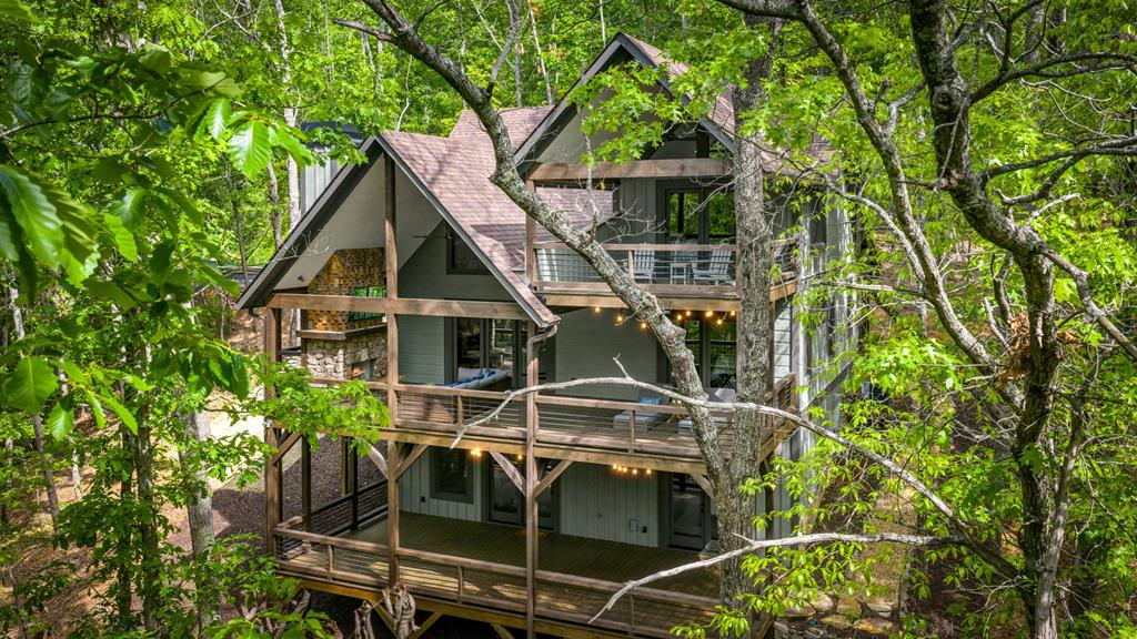 895 Price Road Blue Ridge, GA 30513 - Photo 131 of 140 a view of a house with large windows and a small yard