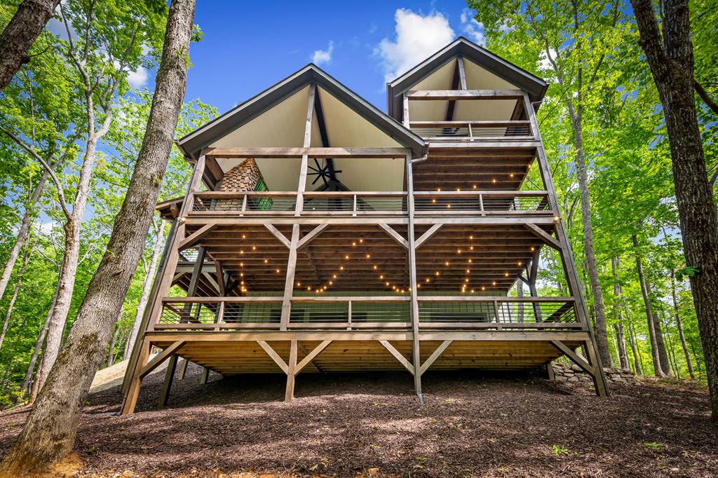 895 Price Road Blue Ridge, GA 30513 - Photo 136 of 140 a view of a house with a wooden deck and a large window