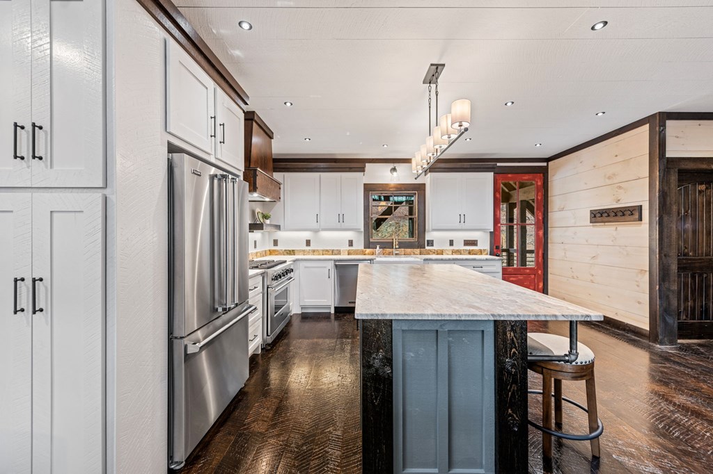 895 Price Road Blue Ridge, GA 30513 - Photo 26 of 140 a kitchen with stainless steel appliances granite countertop a refrigerator a sink dishwasher a stove and a dining table with wooden floor