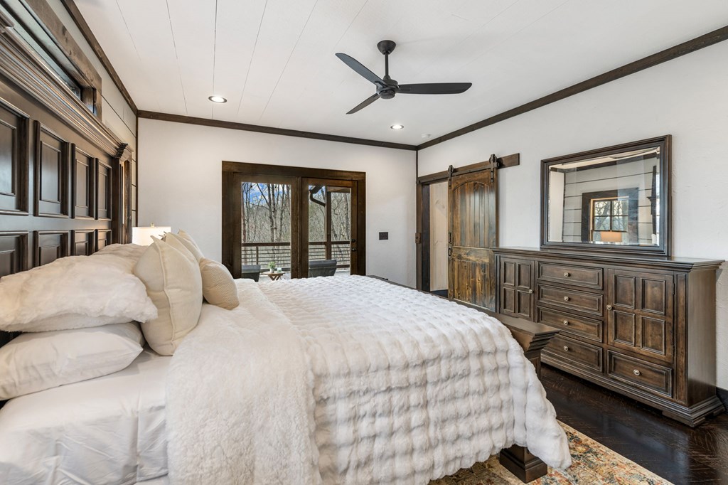 895 Price Road Blue Ridge, GA 30513 - Photo 33 of 140 a bedroom with a large bed and a chandelier