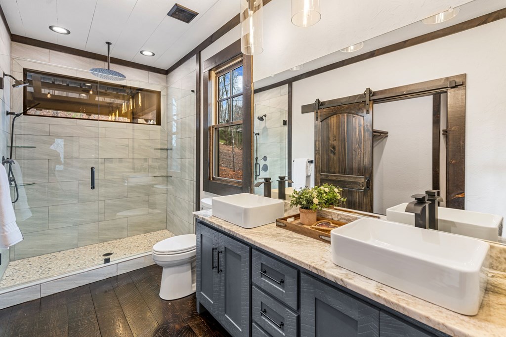 895 Price Road Blue Ridge, GA 30513 - Photo 34 of 140 a bathroom with a double vanity sink toilet mirror and shower