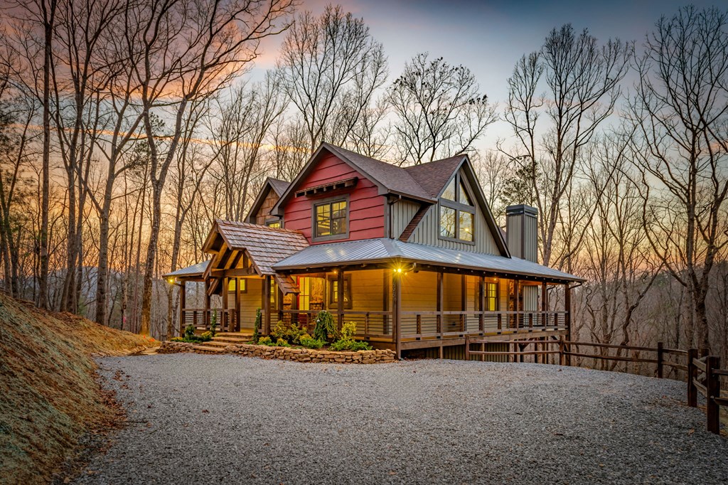 895 Price Road Blue Ridge, GA 30513 - Photo 35 of 140 a view of a large house with large trees and wooden fence