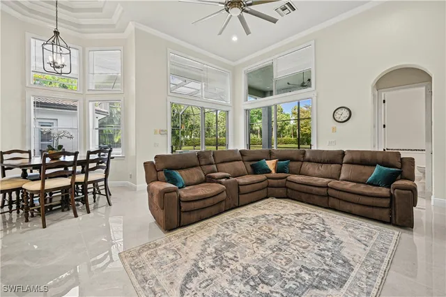 a living room with furniture windows and a chandelier