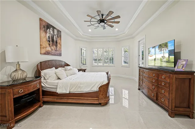 a spacious bedroom with a bed and a dresser