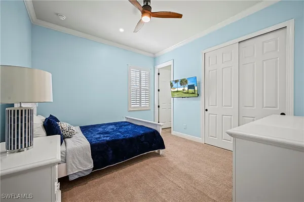 a bedroom with a bed and a lamp
