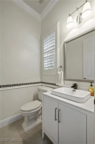 a bathroom with a sink a toilet and mirror