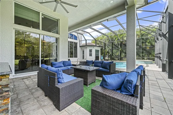 a living room with furniture and a floor to ceiling window