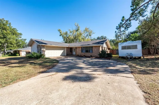 a front view of a house with a yard and a garage