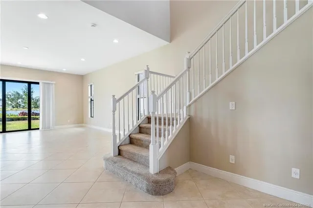 a view of staircase with white walls and windows