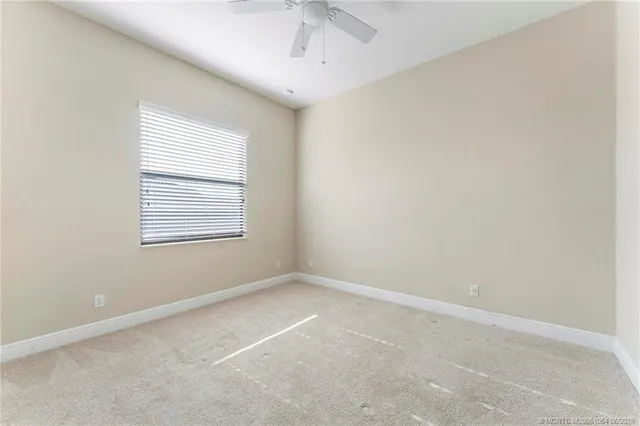 an empty room with windows and stairs
