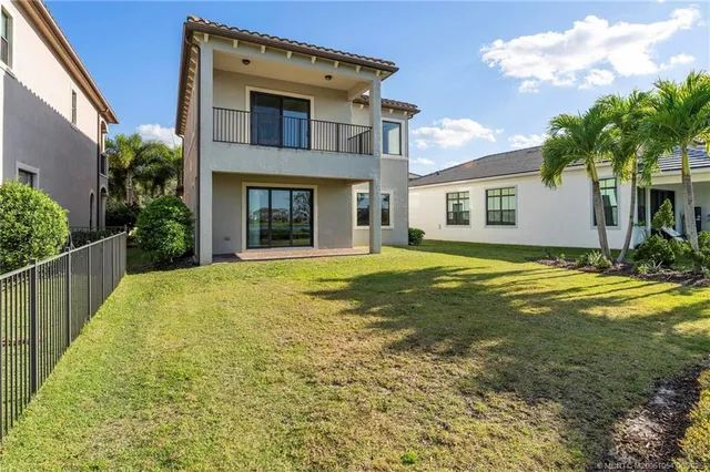 a view of a house with garden and palm tree
