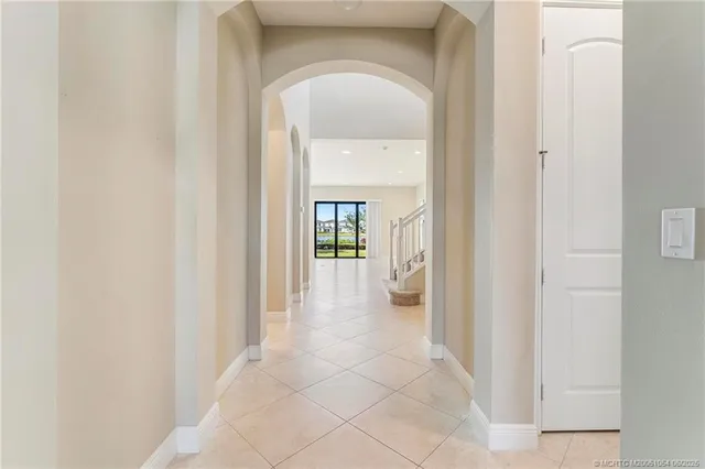 a view of a hallway with a dining room and a mirror
