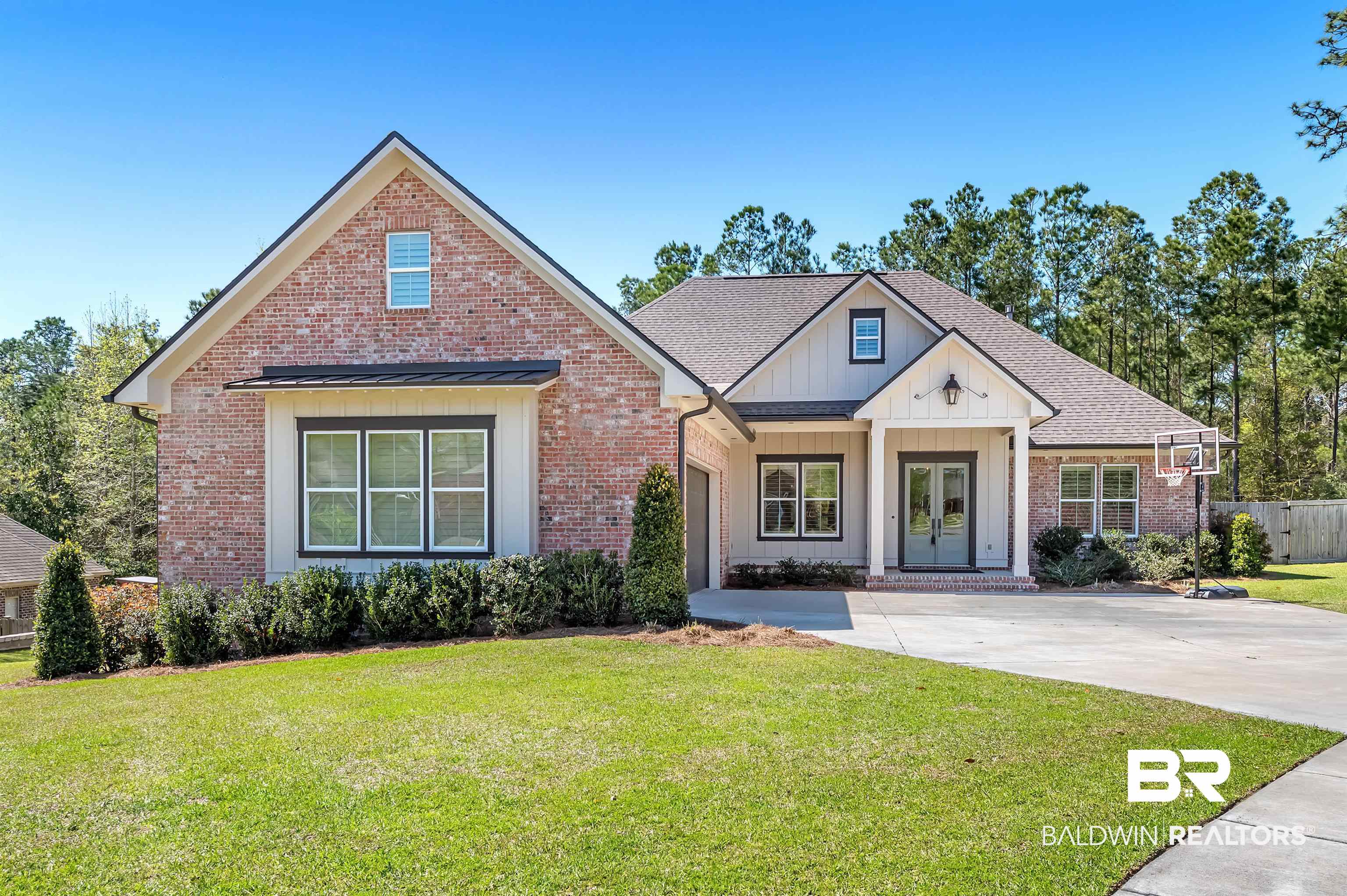27888 Oakachoy Loop Daphne, AL 36526 - Photo 1 of 65 View of front of property with a front yard, french doors, concrete driveway, brick siding, and board and batten siding