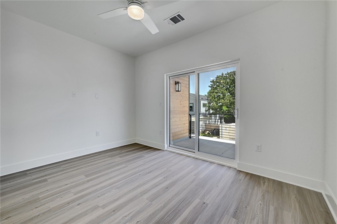 2305 Century Tree Cove Austin, TX 78723 - Photo 14 of 22 an empty room with wooden floor and windows