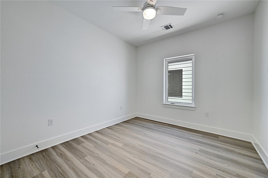 2305 Century Tree Cove Austin, TX 78723 - Photo 15 of 22 wooden floor in an empty room with a window