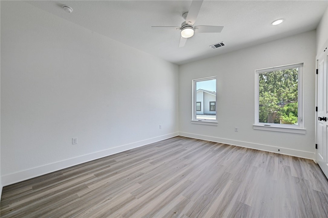 2305 Century Tree Cove Austin, TX 78723 - Photo 16 of 22 an empty room with wooden floor and windows