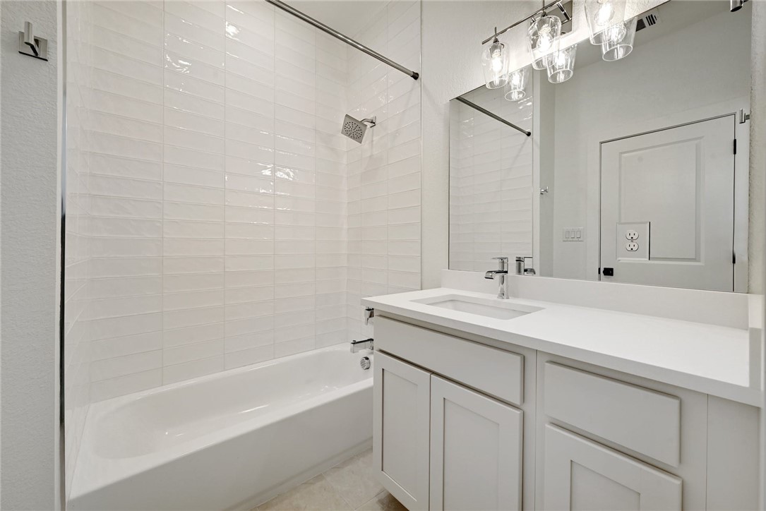 2305 Century Tree Cove Austin, TX 78723 - Photo 17 of 22 a bathroom with a sink double vanity granite tub shower and a mirror