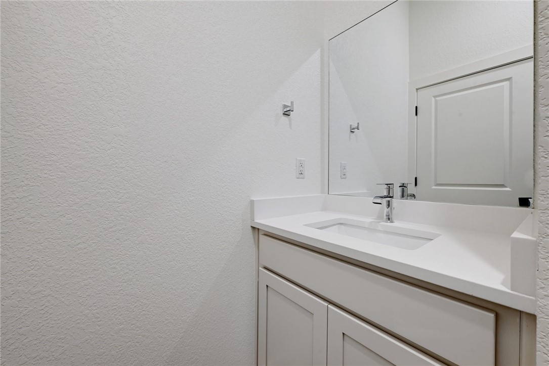2305 Century Tree Cove Austin, TX 78723 - Photo 18 of 22 a bathroom with a sink and a mirror