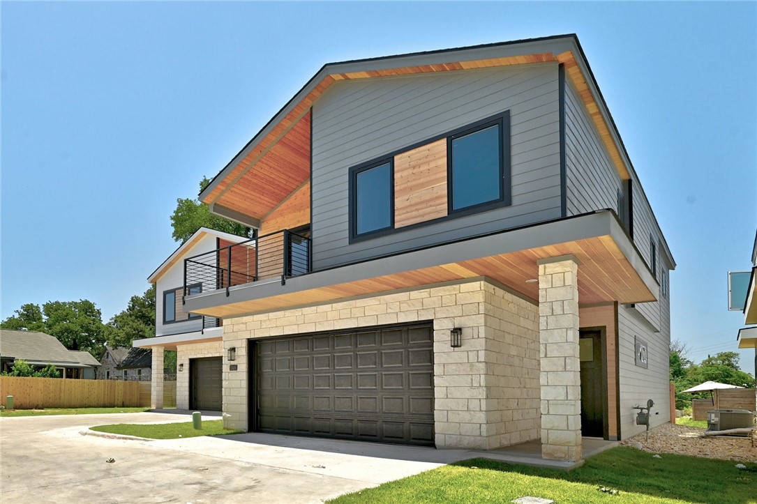 2305 Century Tree Cove Austin, TX 78723 - Photo 2 of 22 a front view of a house with a yard