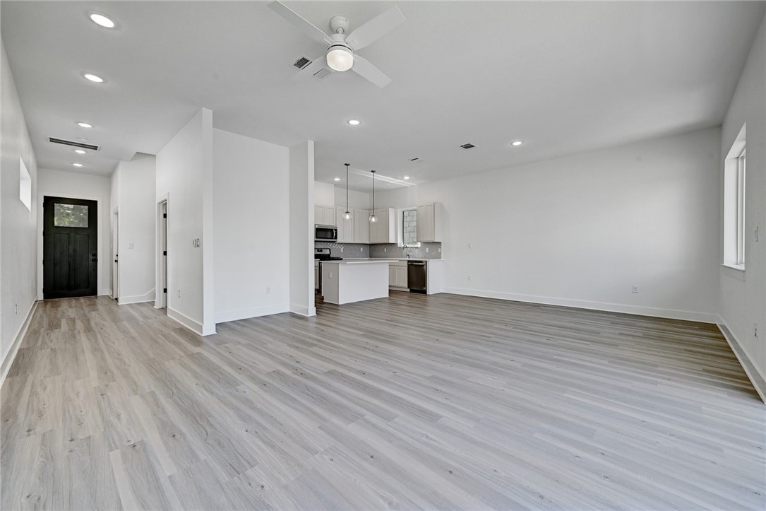 2305 Century Tree Cove Austin, TX 78723 - Photo 3 of 22 a view of empty room with wooden floor and window