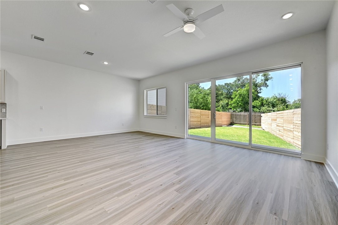 2305 Century Tree Cove Austin, TX 78723 - Photo 5 of 22 a view of an empty room with wooden floor and a window