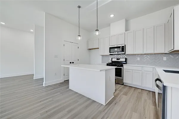 a kitchen with cabinets wooden floor and a sink