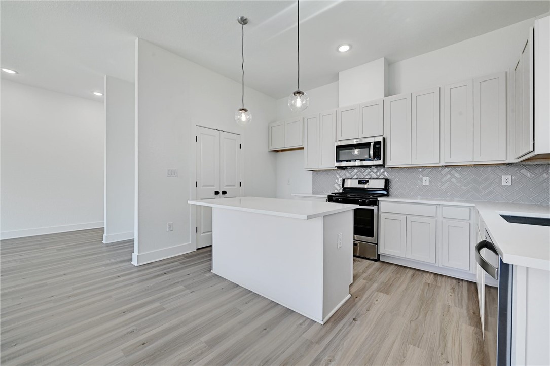 2305 Century Tree Cove Austin, TX 78723 - Photo 9 of 22 a kitchen with cabinets wooden floor and a sink