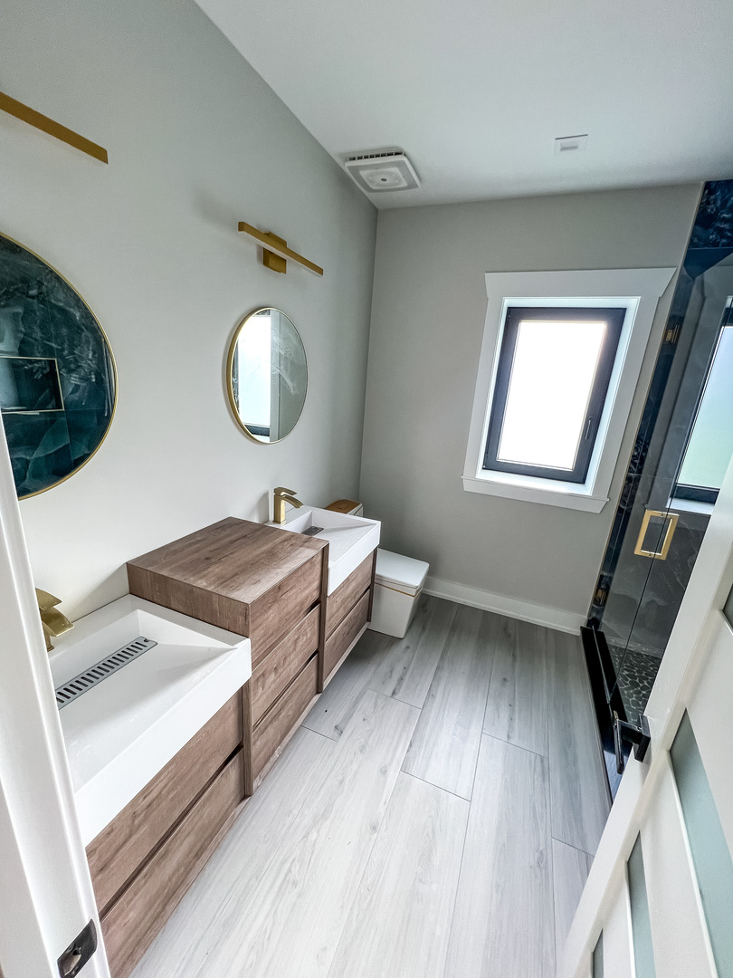 9517 Forest Place Des Plaines, IL 60016 - Photo 12 of 14 a bathroom with a sink mirror and vanity