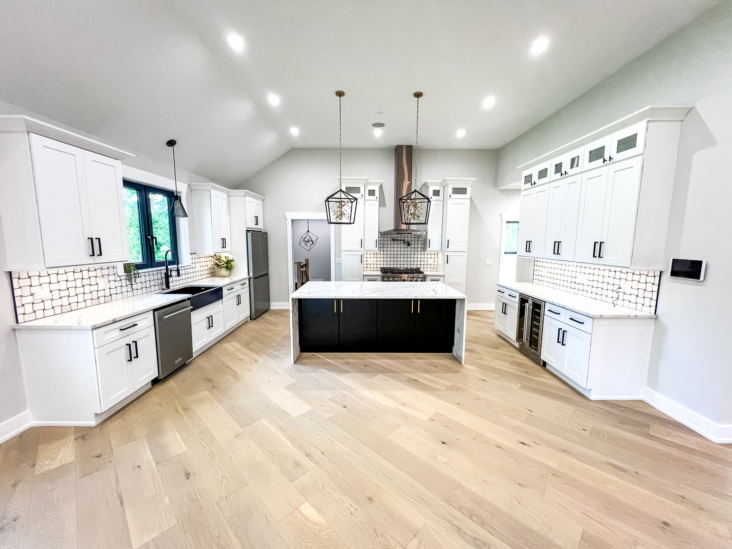 9517 Forest Place Des Plaines, IL 60016 - Photo 2 of 14 a large white kitchen with a large counter top a sink stainless steel appliances and cabinets