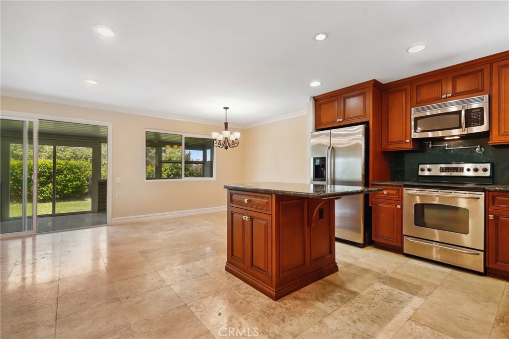 3413 Punta Alta, Unit A Laguna Woods, CA 92637 - Photo 9 of 45 a kitchen with stainless steel appliances granite countertop a stove a sink and a microwave
