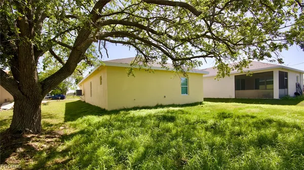a view of a house with large trees