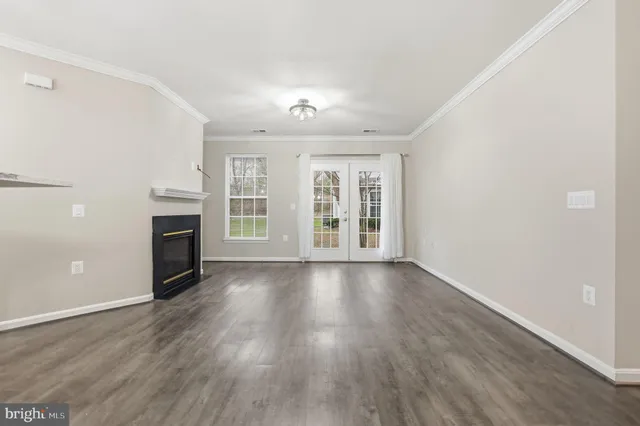 a view of a room with wooden floor and fire place