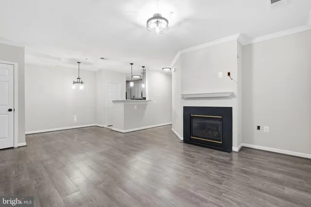 a view of a room with wooden floor and white walls