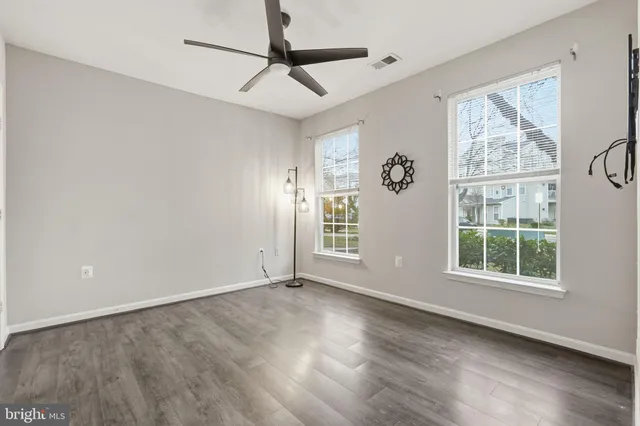 a bathroom with a bathtub shower sink vanity mirror and toilet