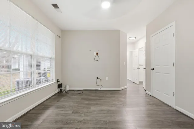 a view of walk in closet with empty racks